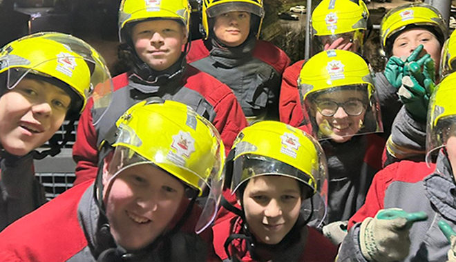 group photo of fire cadets in uniform all smiling
