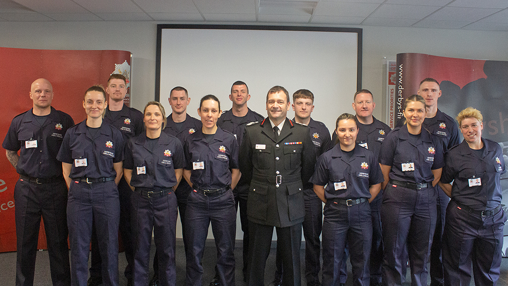 Wholetime recruits standing with the chief fire officer