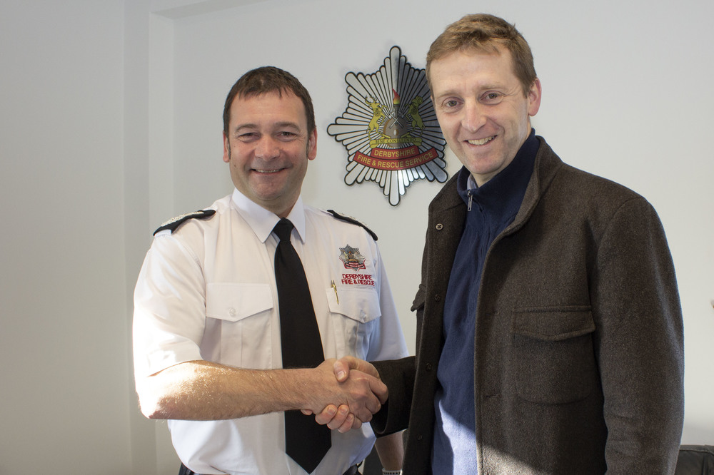 Chief fire officer Gavin Tomlinson shaking hands with the High Sheriff